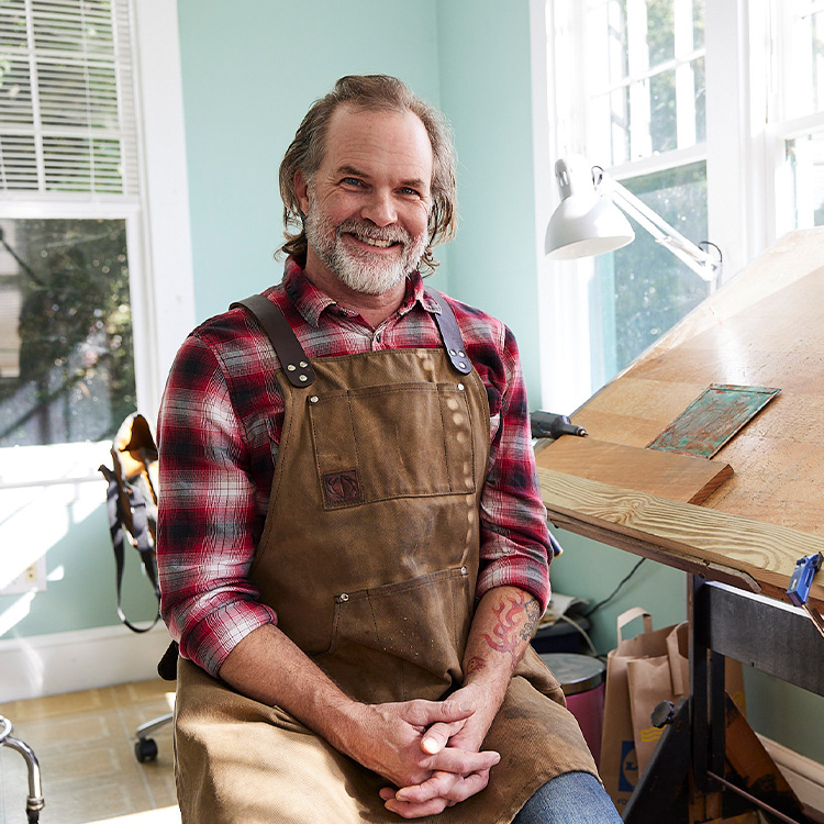 business owner standing in front of a woodshop